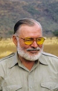 Hemingway with glasses and beard